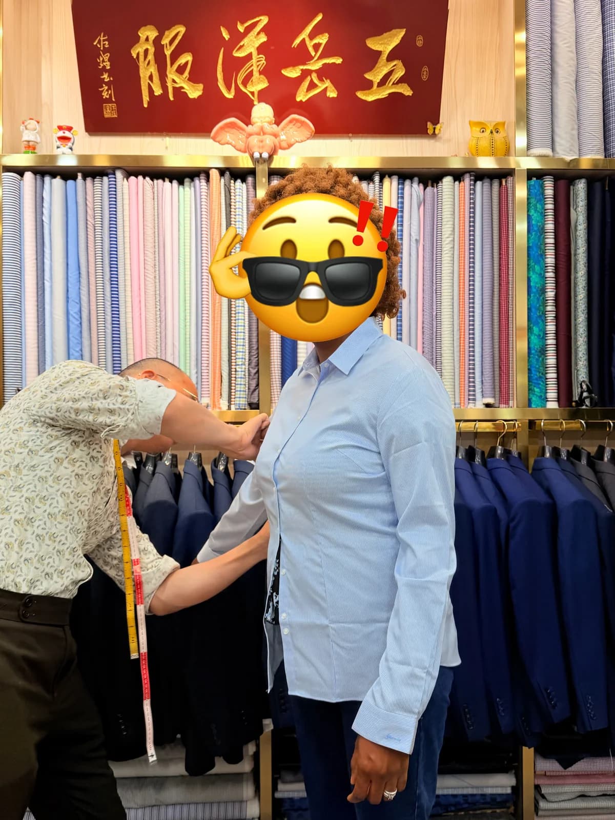 Wuyue tailor measuring a female client for custom business suits at Shop 256 in Shanghai