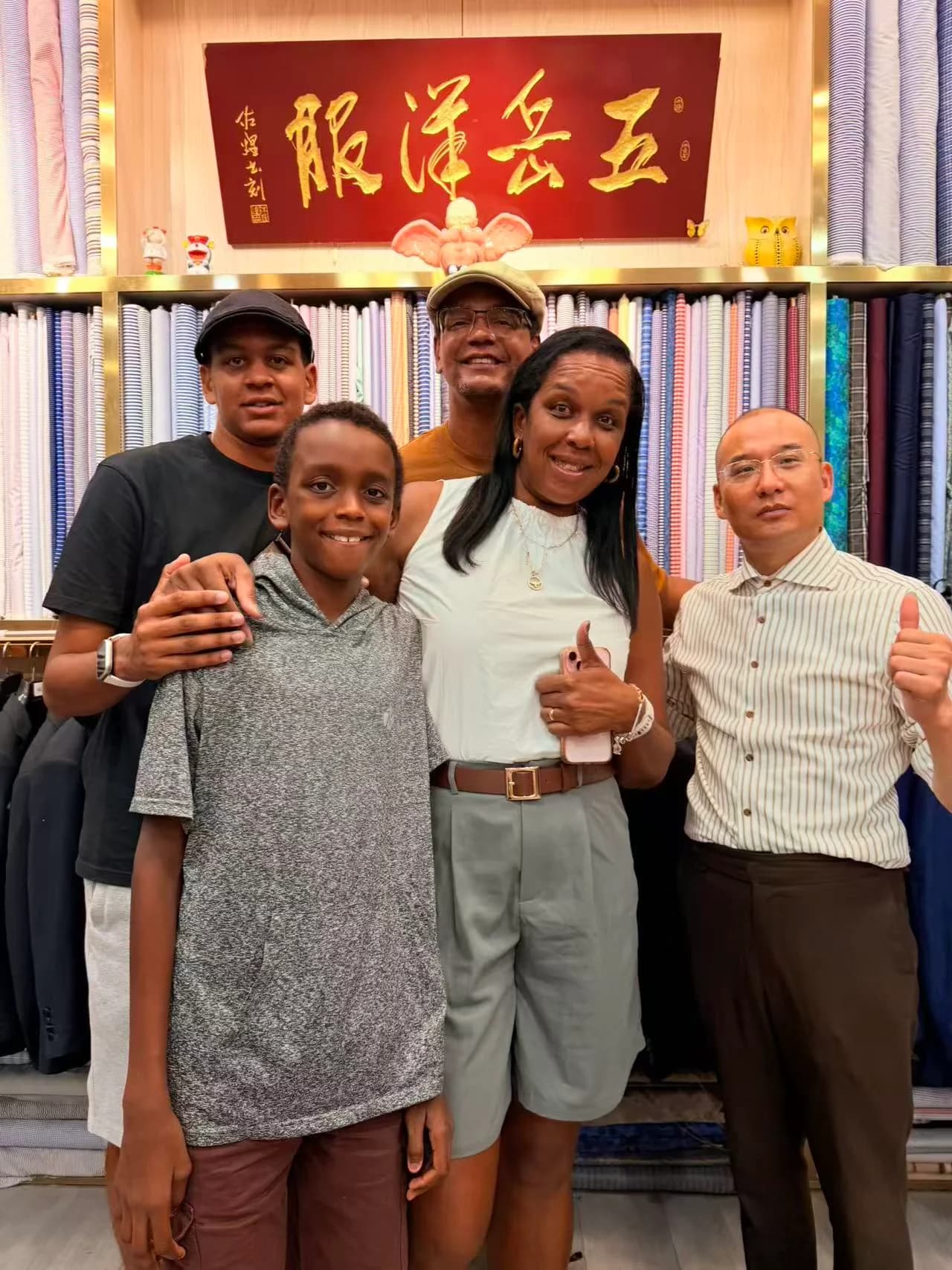 Family visiting Wuyue Bespoke Tailoring together at a Shanghai fabric market