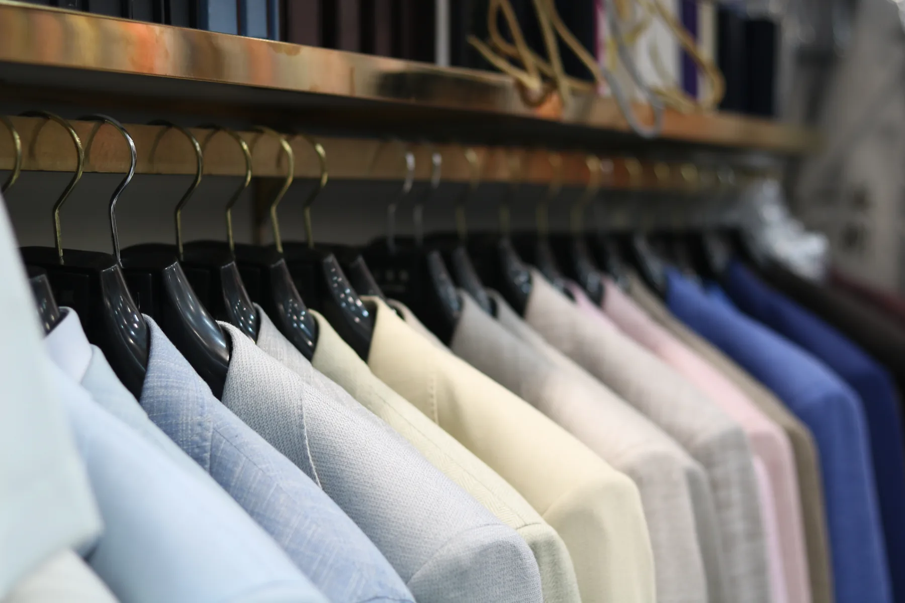 A close view along a rail of jackets in different colours
