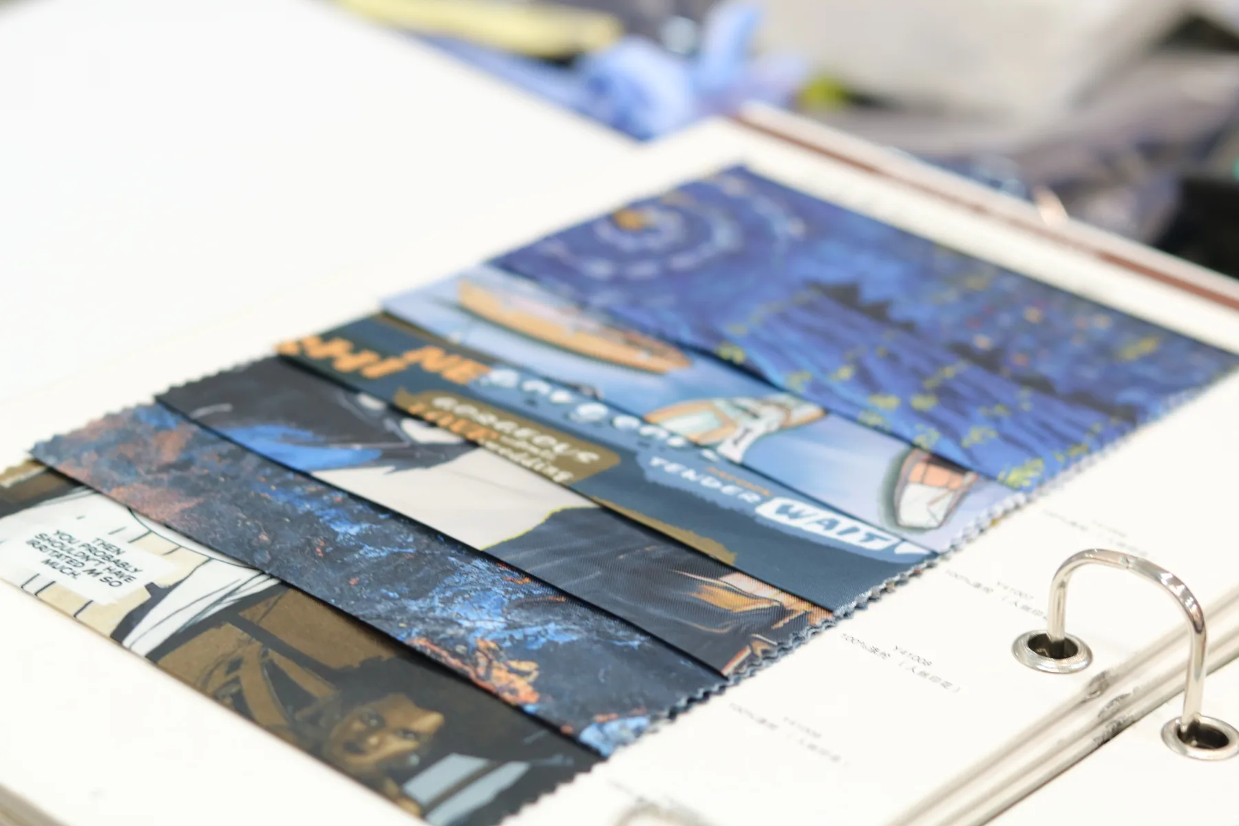 A spread of patterned lining samples in a sample book