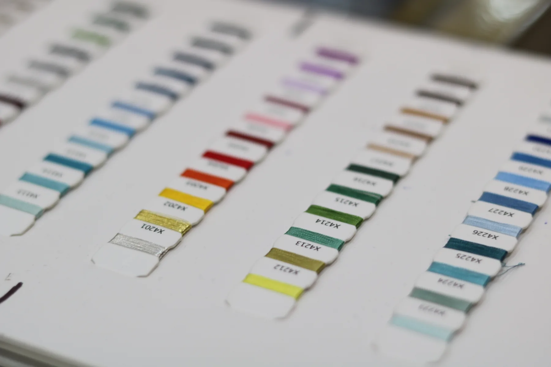 Thread colour samples arranged in rows in a sample book