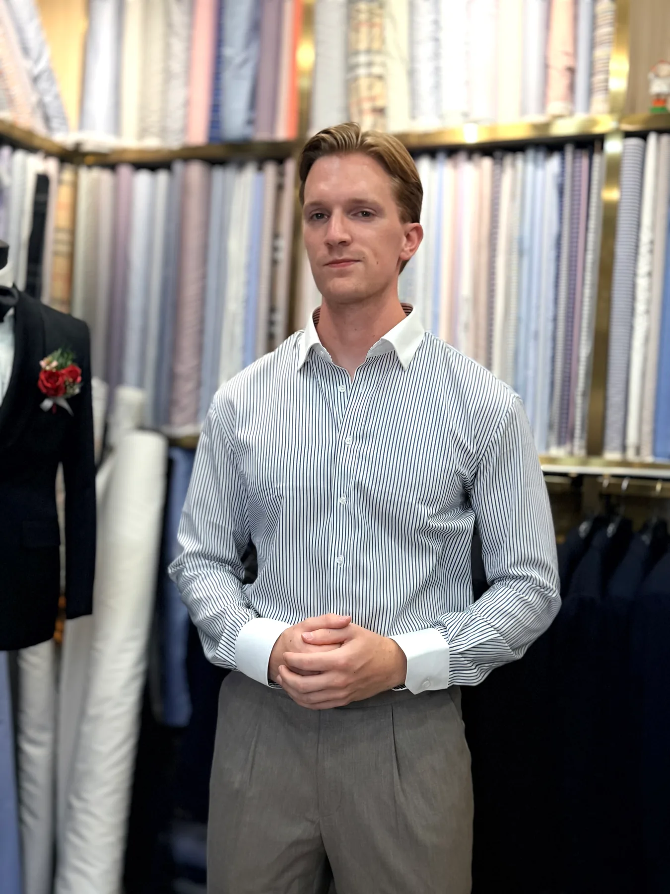 Member of the Dutch group wearing a pale-blue shirt and taupe trousers inside Wuyue