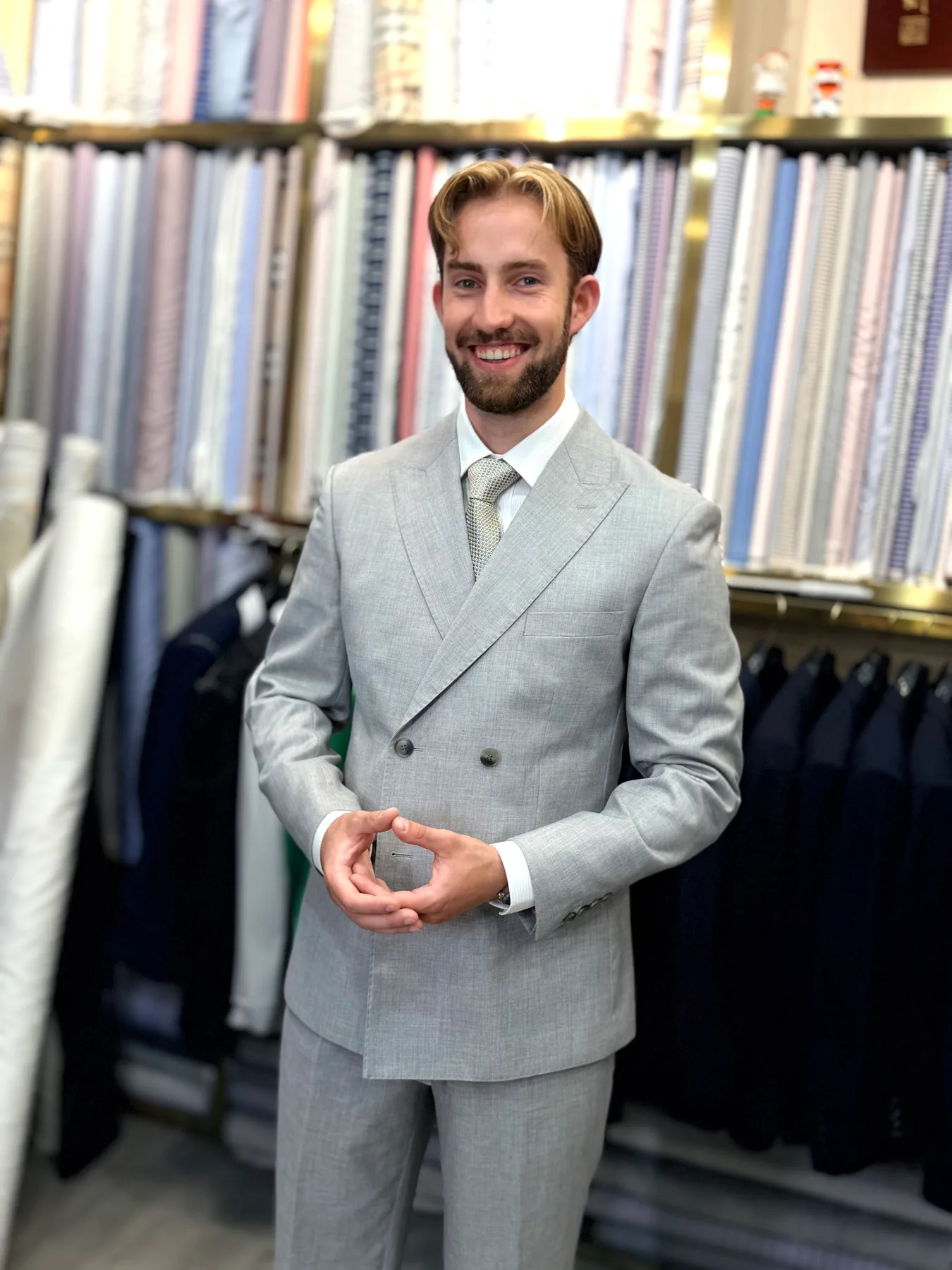 Closer portrait of the light-colored double-breasted suit with a white shirt and pale tie
