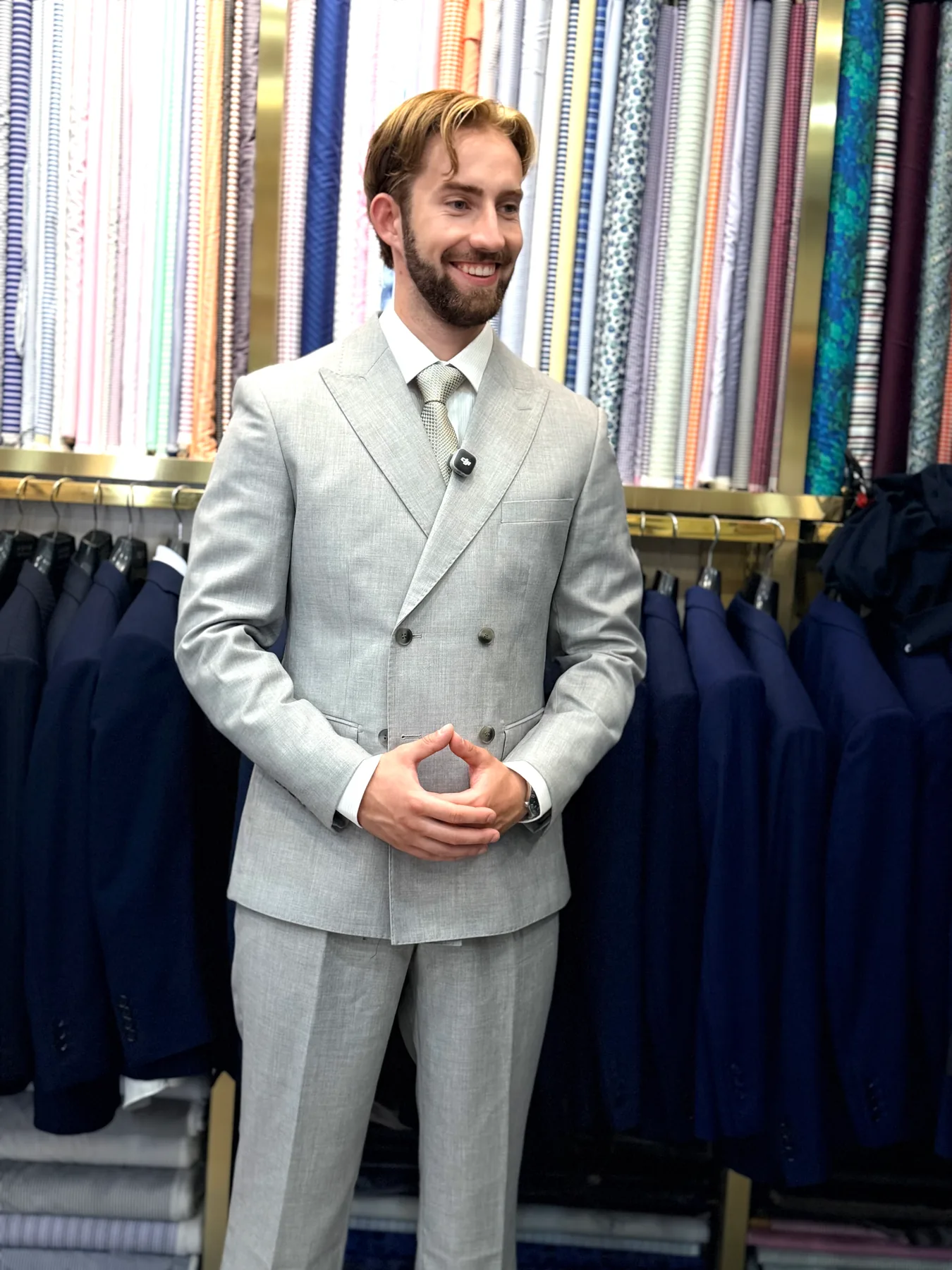 Three-quarter view of a light-colored double-breasted suit with peak lapels