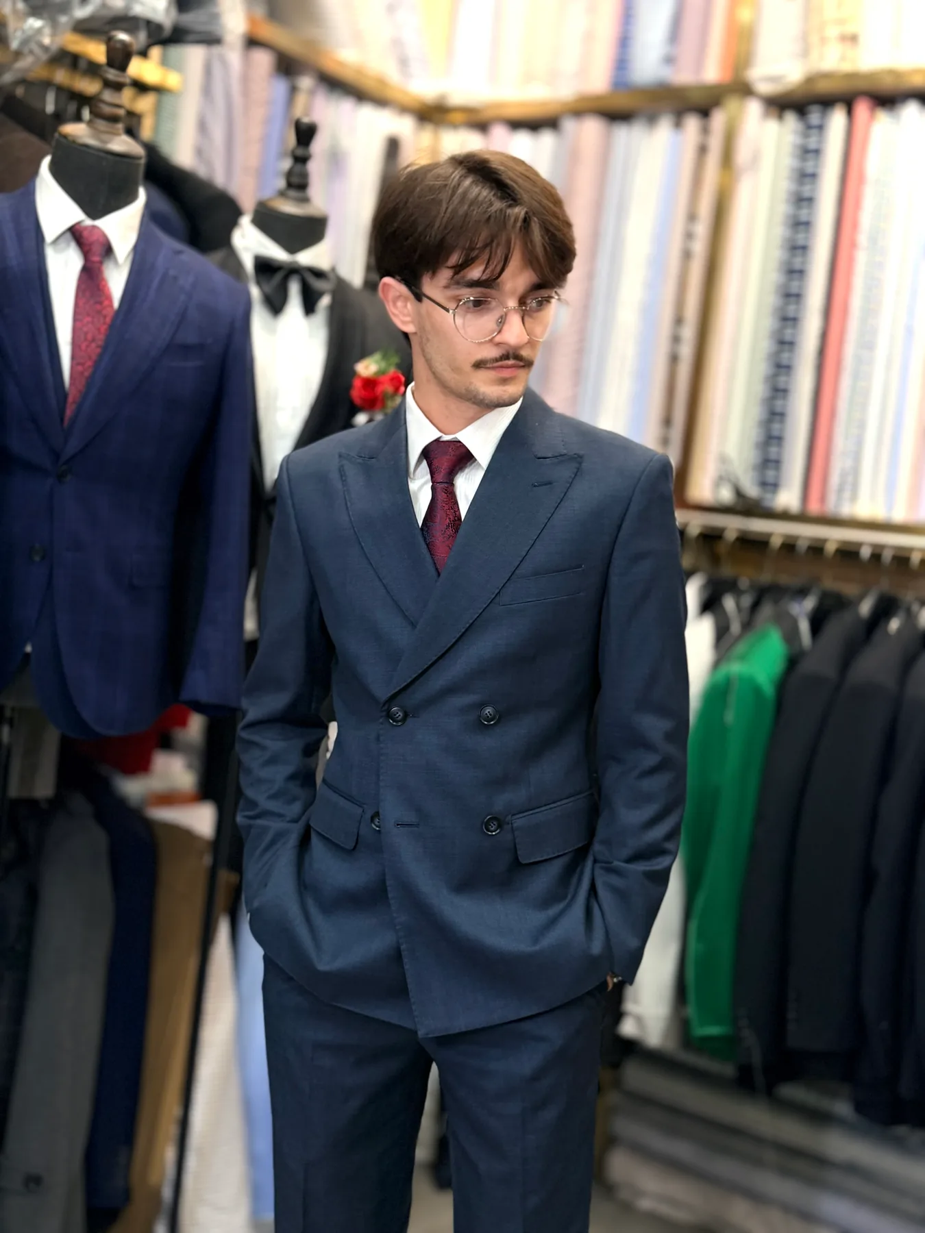 Client in a navy double-breasted suit with peak lapels and a burgundy tie at Wuyue