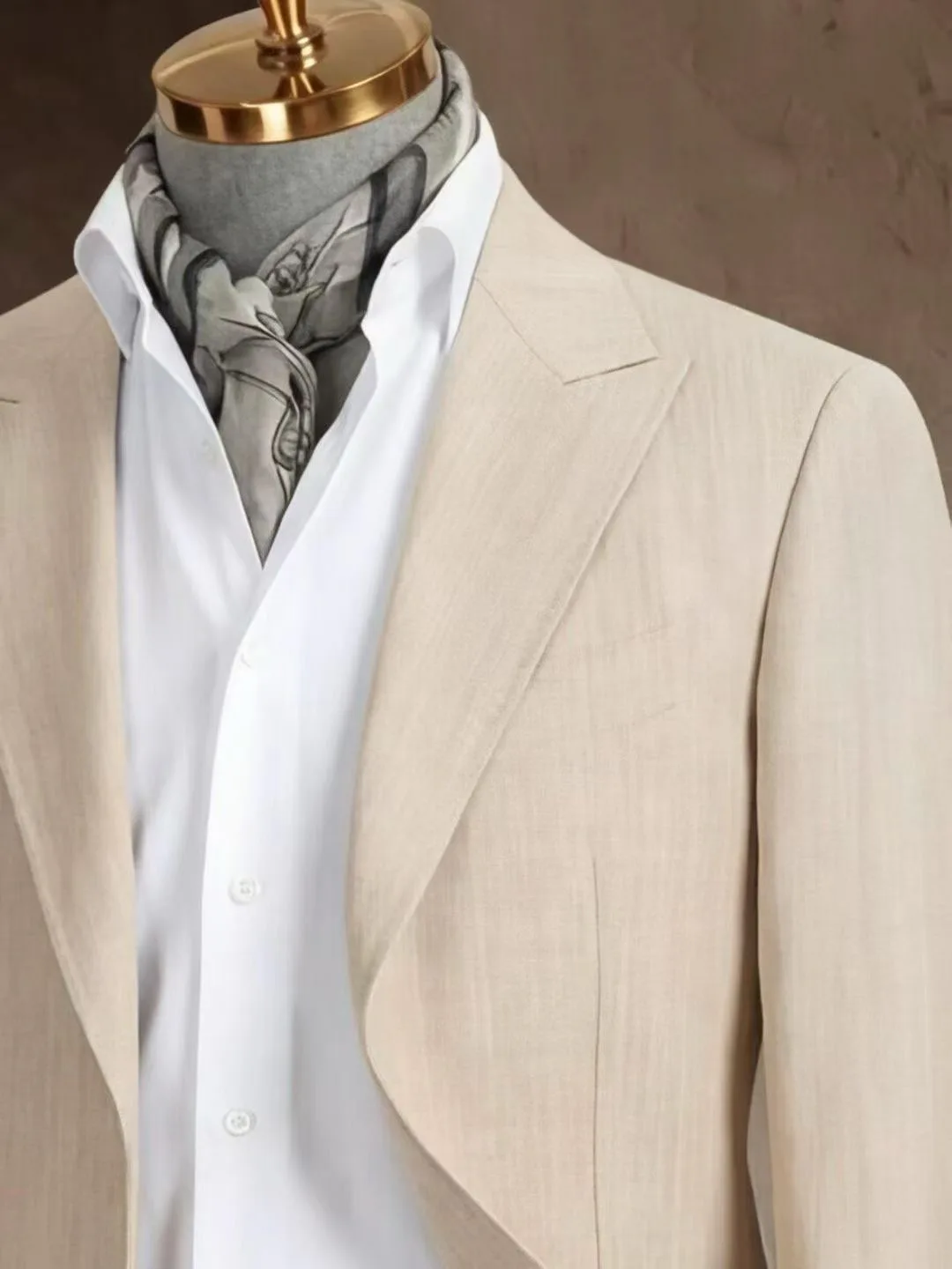 Light beige custom suit jacket displayed with a white shirt and grey silk scarf