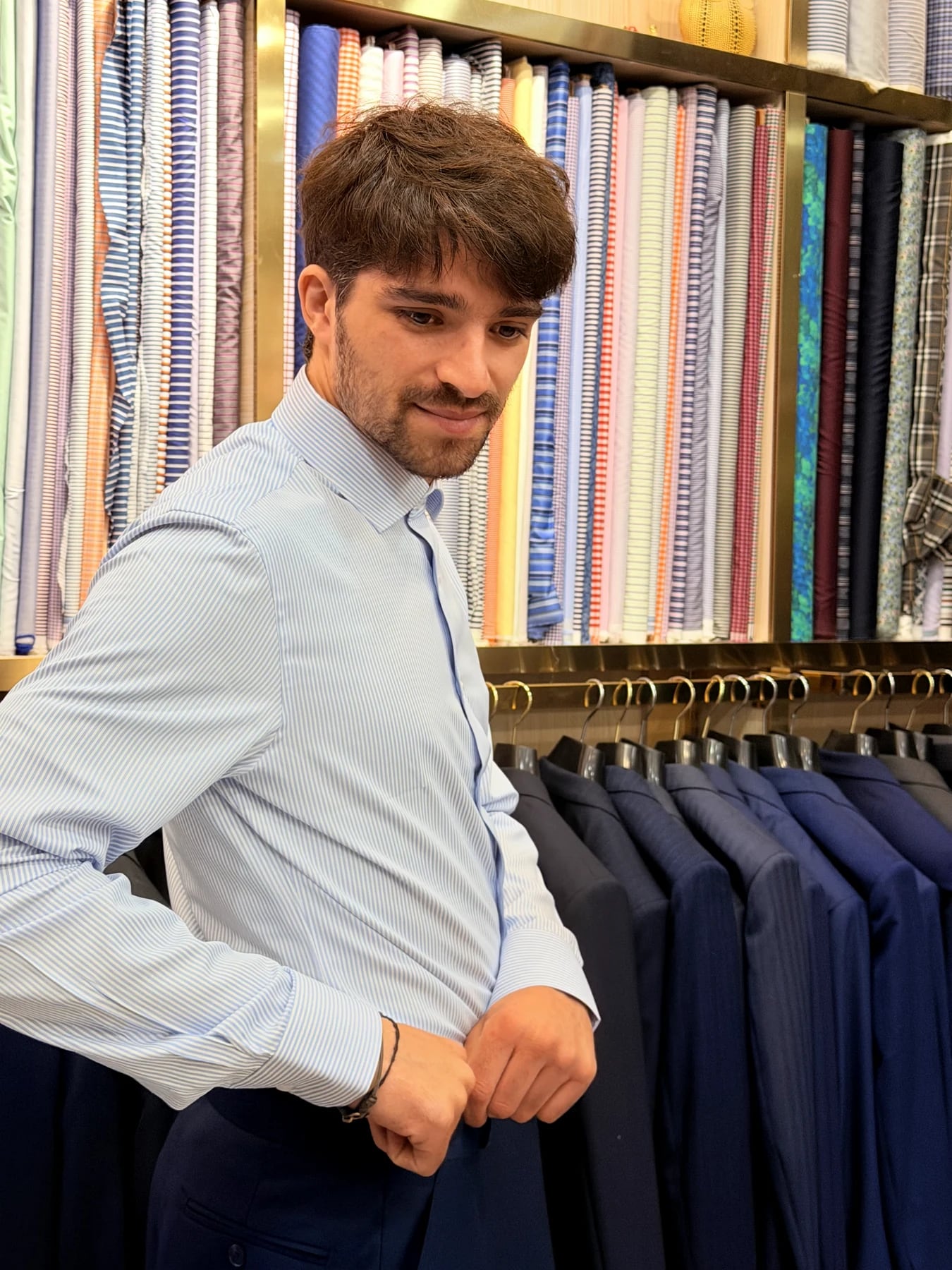 Side view of the client in a blue striped shirt during the Wuyue suit appointment