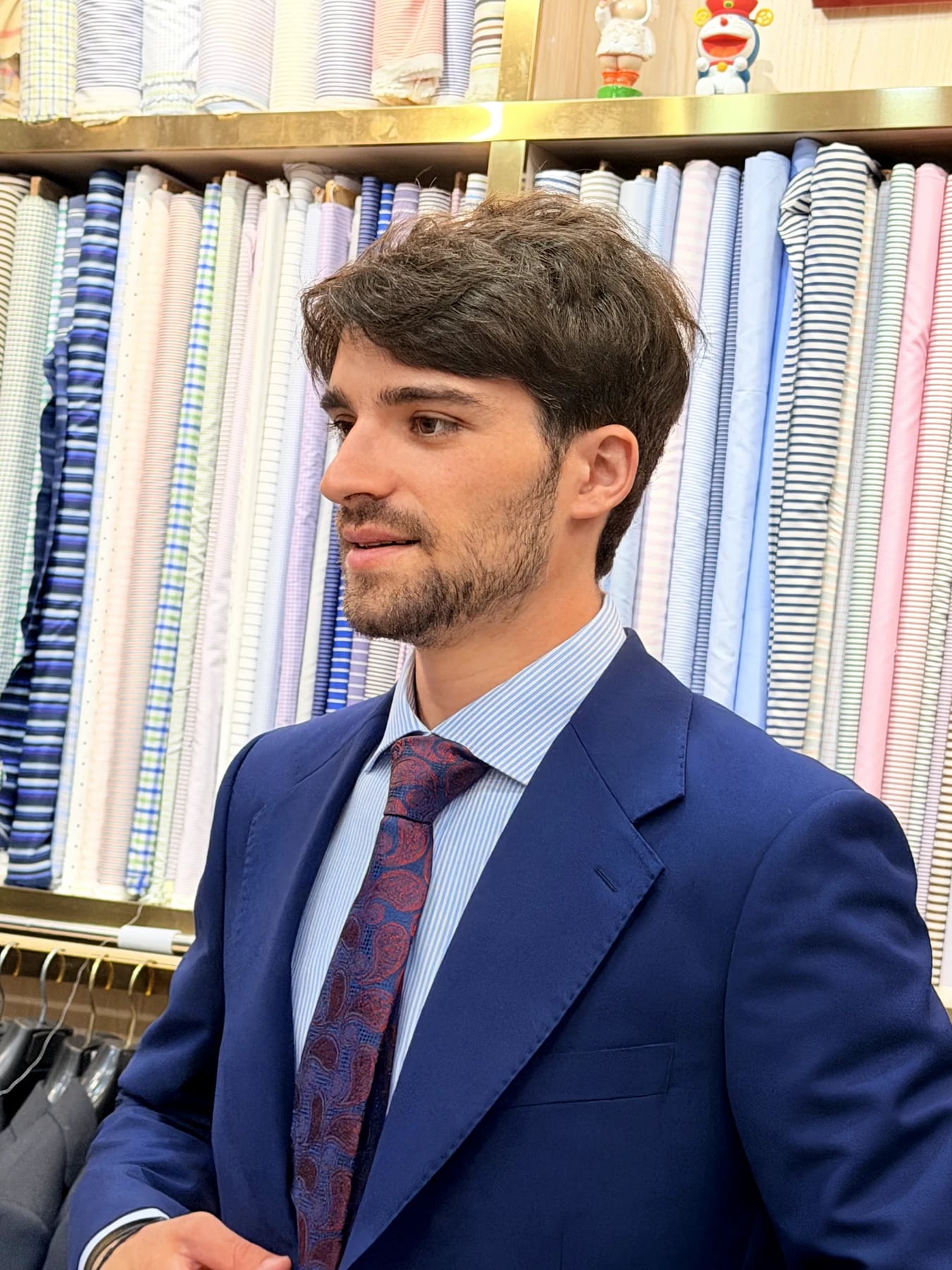 Close three-quarter view of the shoulder and lapel on a finished French blue suit