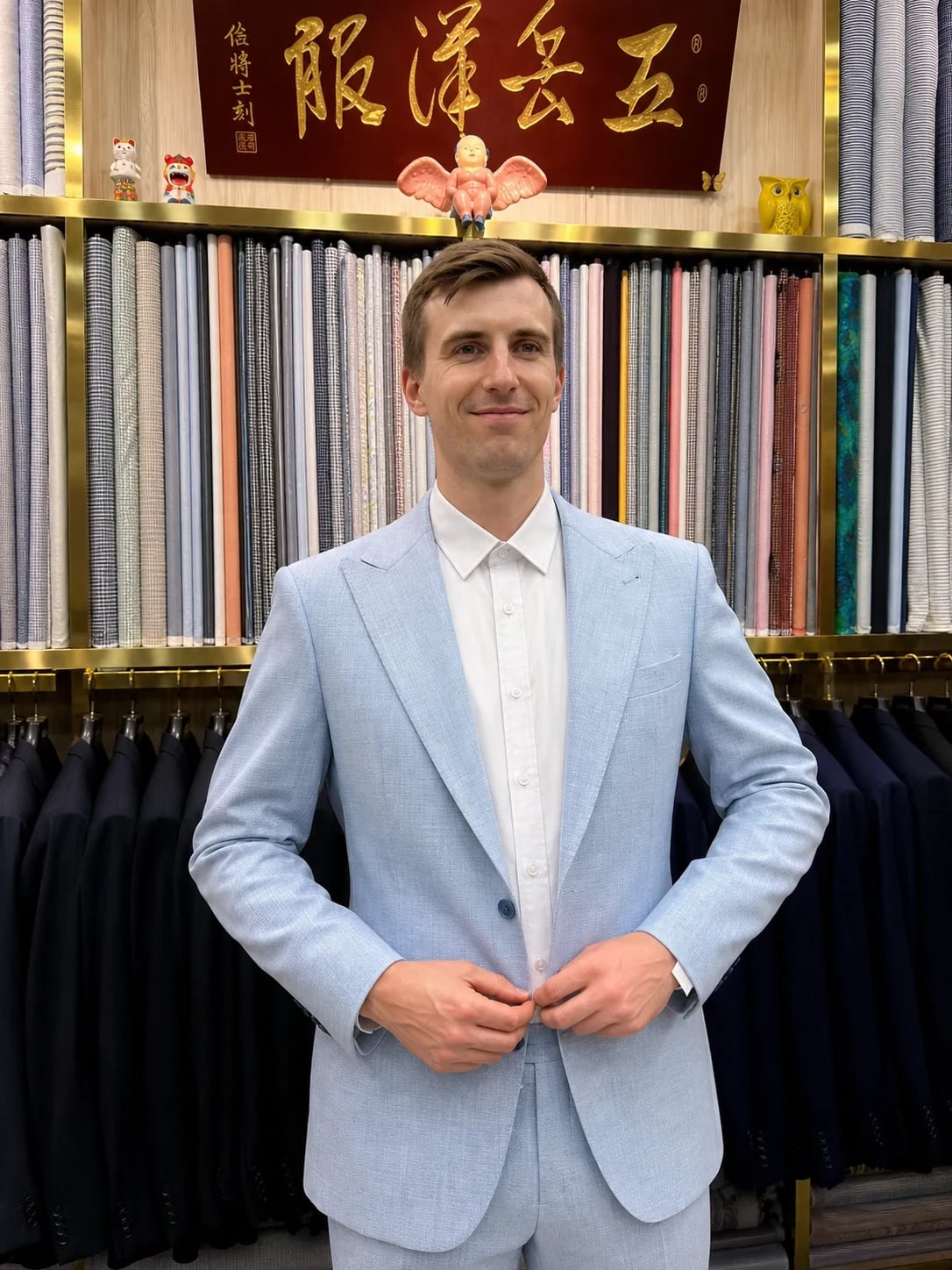 Full front view of a pale-blue suit with notch lapels and white shirt at Wuyue