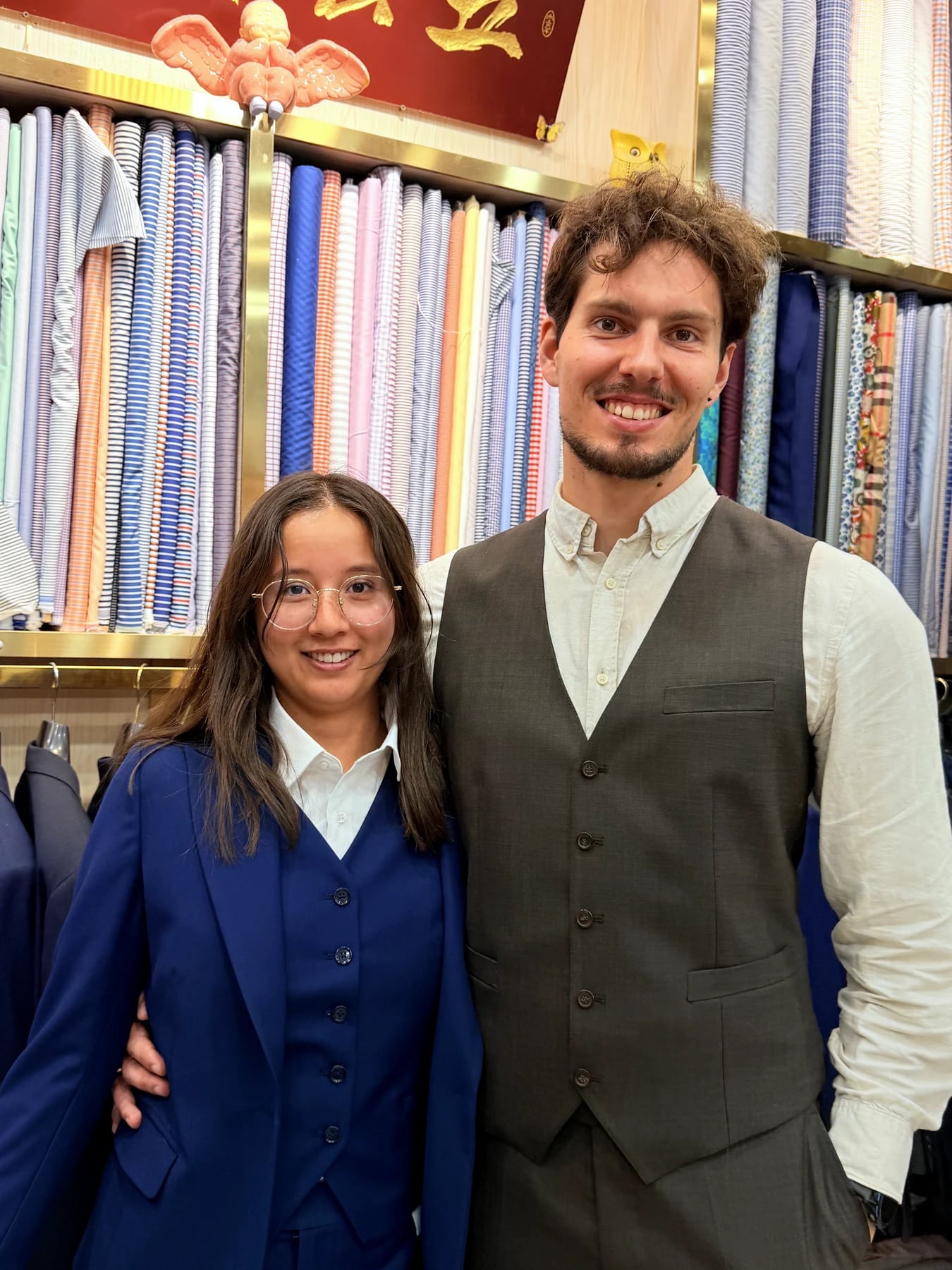 Client in a grey waistcoat standing beside another person in a blue waistcoat at Wuyue