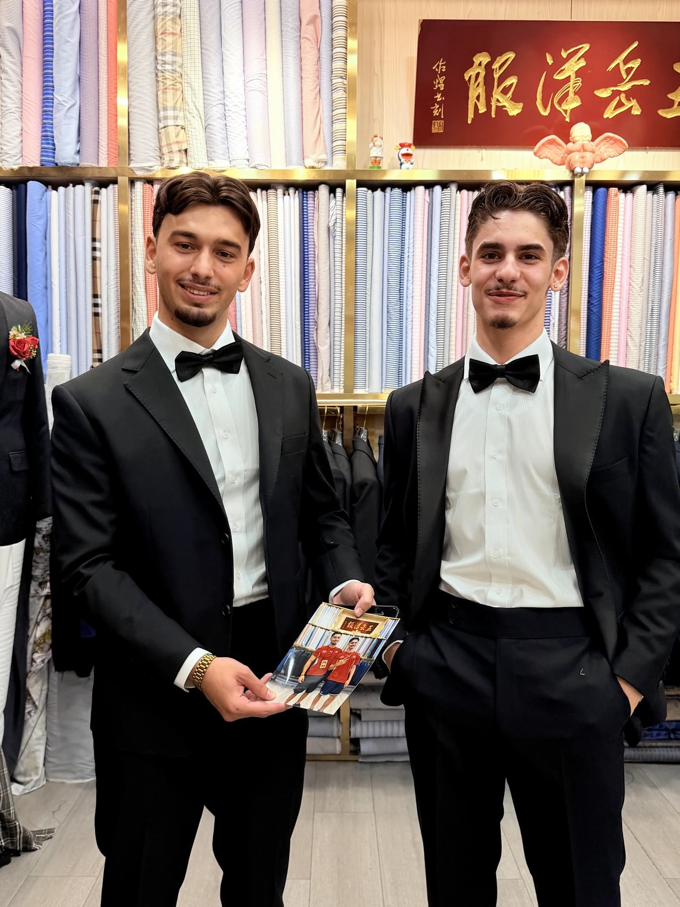 Second front portrait of two finished black tuxedos inside Wuyue Shanghai