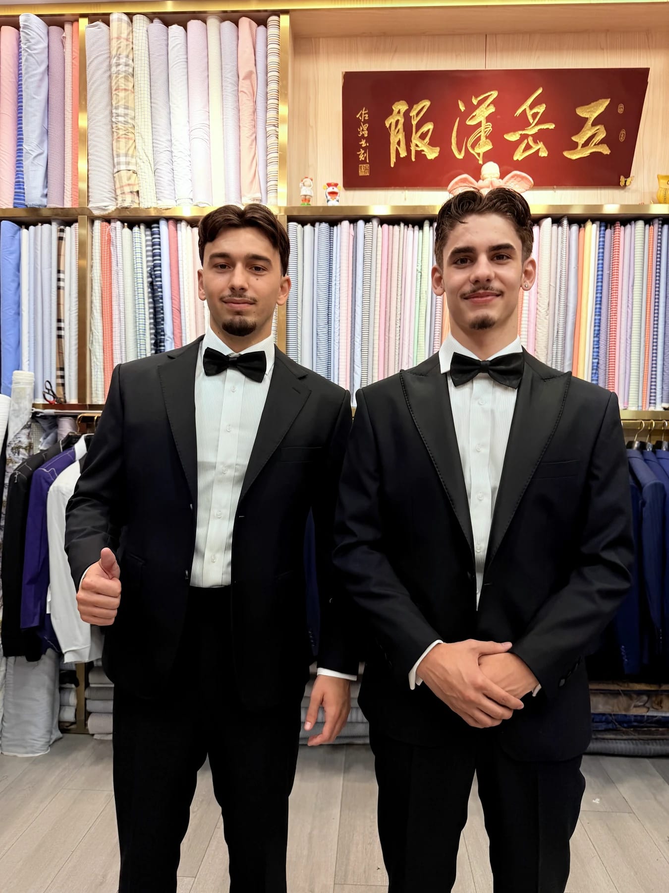 Two clients wearing finished black tuxedos with white shirts and bow ties at Wuyue Shanghai