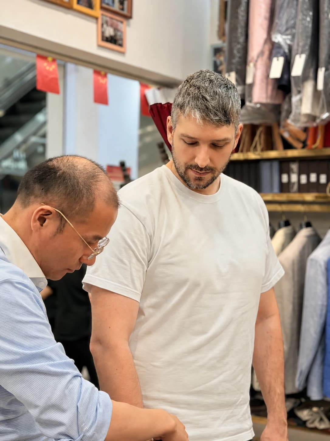Wuyue tailor recording an international client's natural stance before measurements