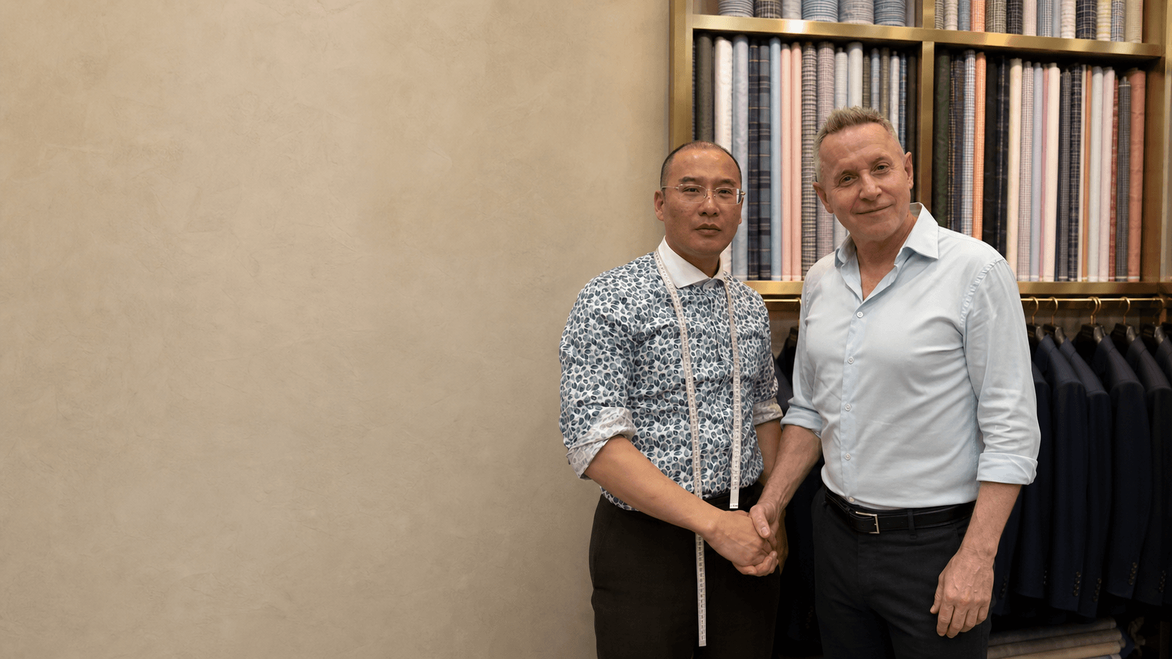 A Wuyue tailor and guest standing together in the Shanghai atelier