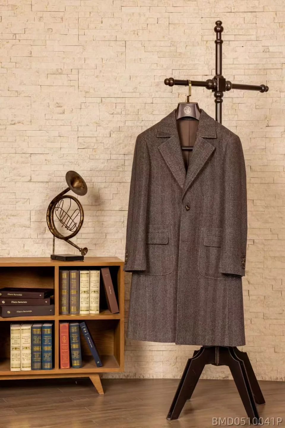 Brown herringbone single-breasted overcoat on a wooden hanger