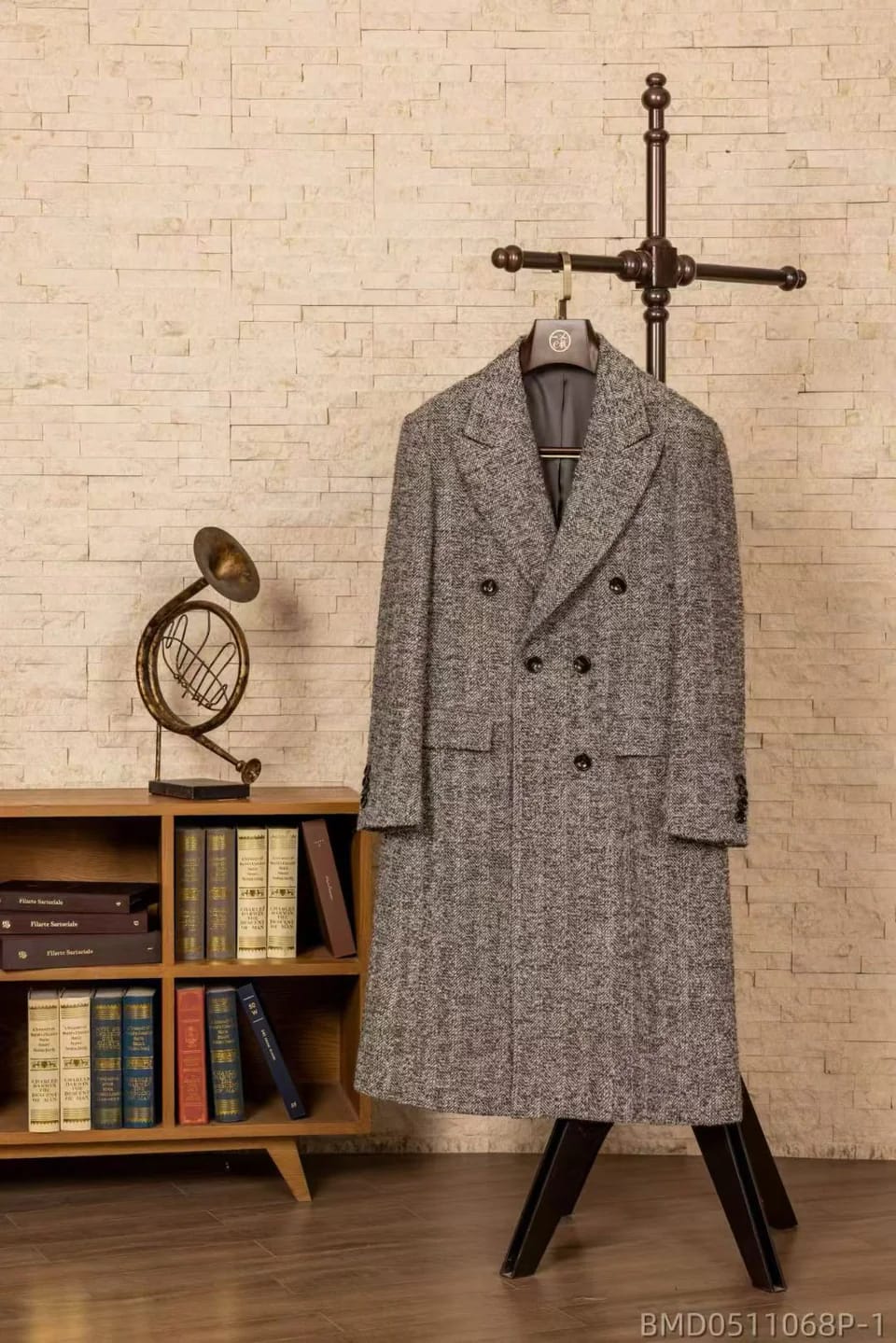 Grey herringbone double-breasted overcoat on a wooden hanger