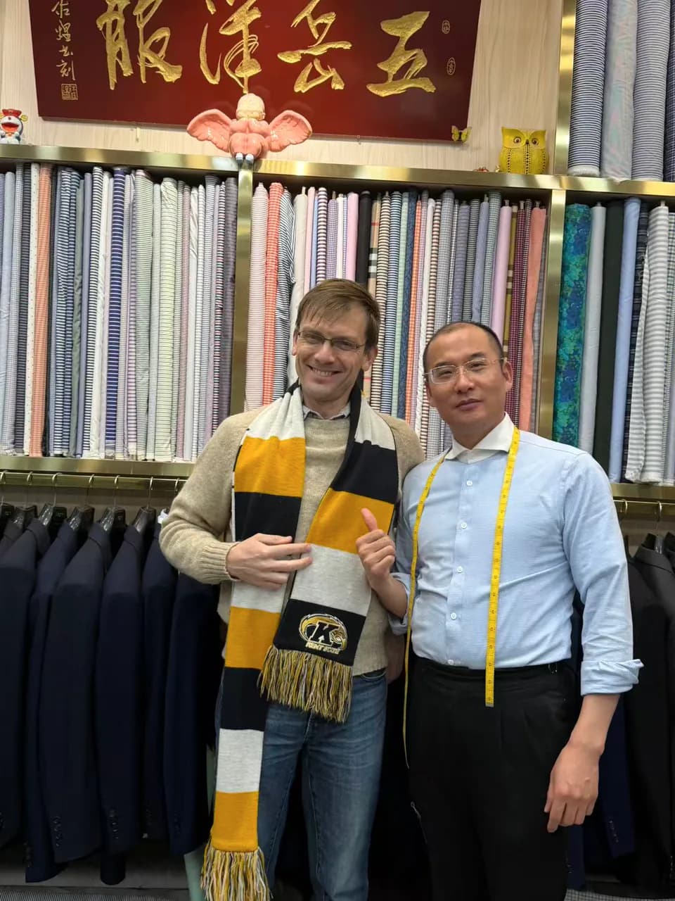 International client with a Wuyue tailor in front of shirting fabrics at South Bund Fabric Market