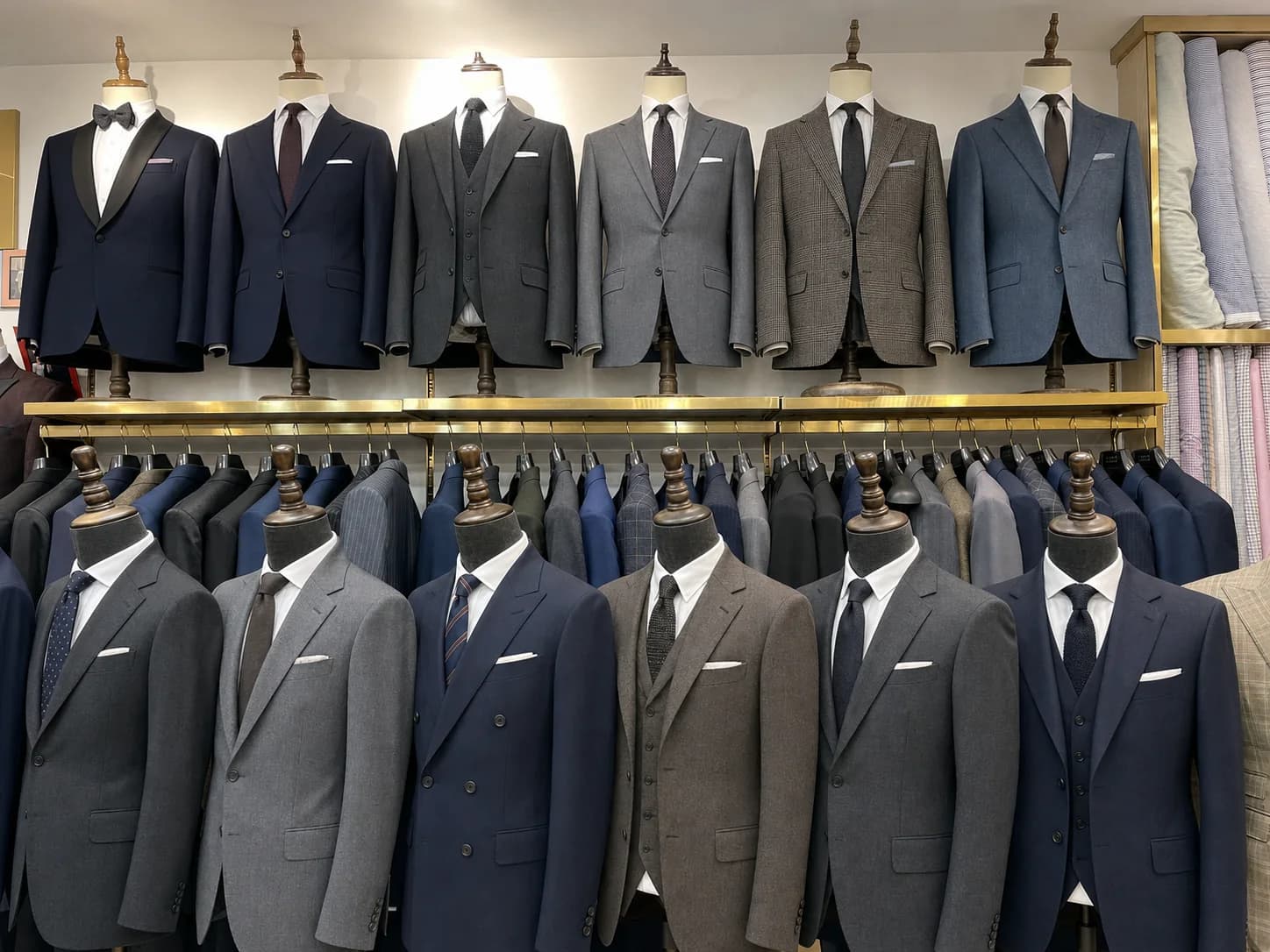 Classic two-piece, three-piece, dinner, and double-breasted suits displayed at Wuyue Bespoke Tailoring in Shanghai