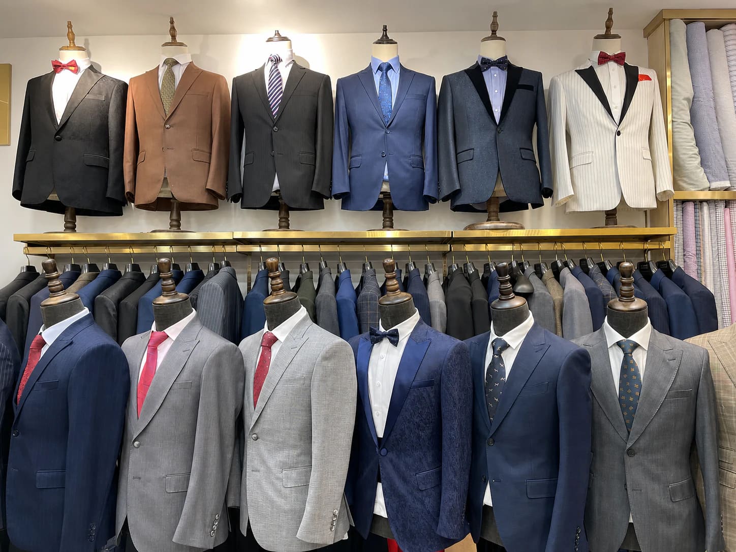 Custom suits and jackets displayed on the wall inside Wuyue Bespoke Tailoring Shanghai